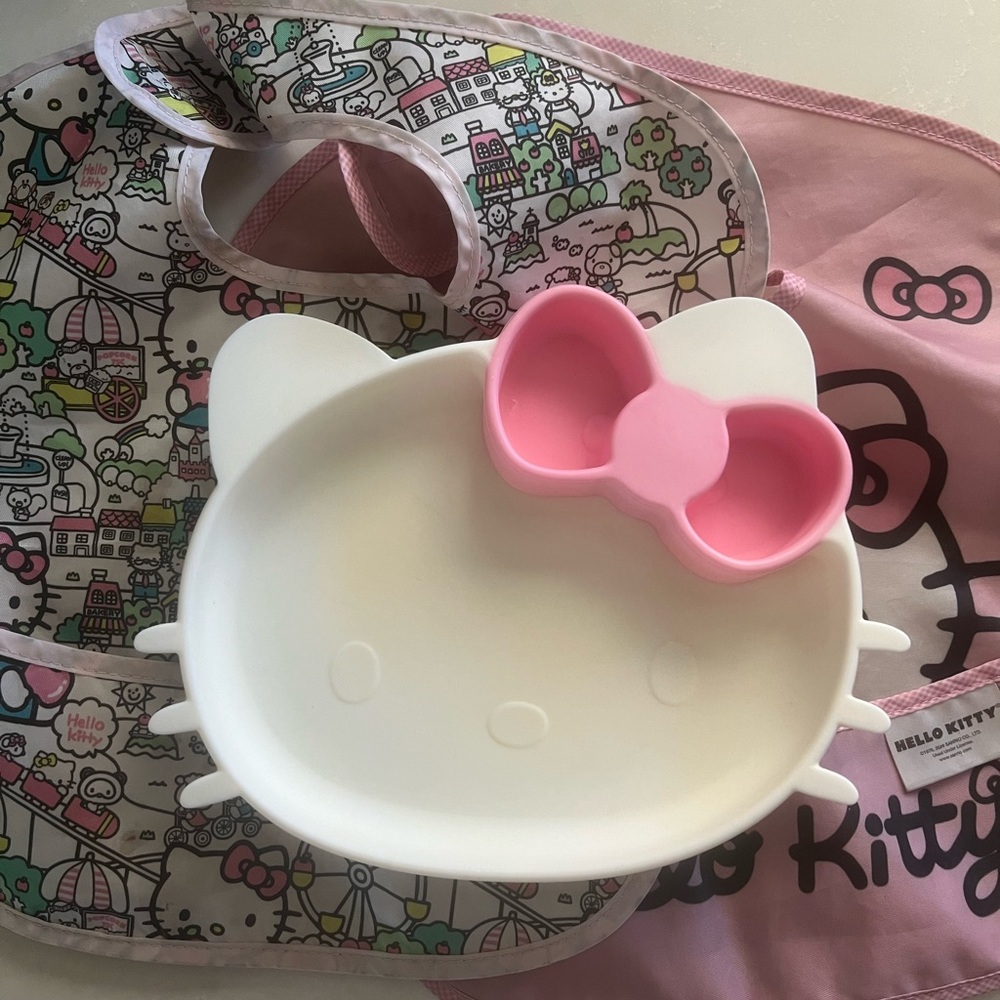 Used Bumkins Hello Kitty Silicone Grip Dish and two bibs.